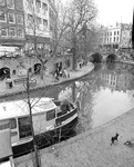 880651 Afbeelding van twee kunstenaressen met omstanders aan het werk op de werf langs de Oudegracht tussen de Jansbrug ...